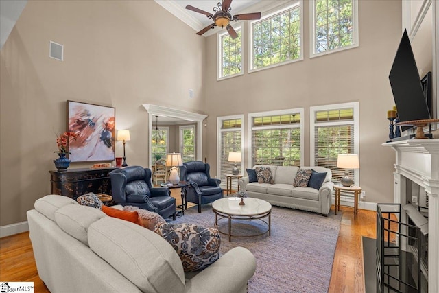 112 Griffith Hill Way, Greer, SC 29650 - living room with a fireplace, a ceiling fan, wood finished floors, crown molding, and a high ceiling