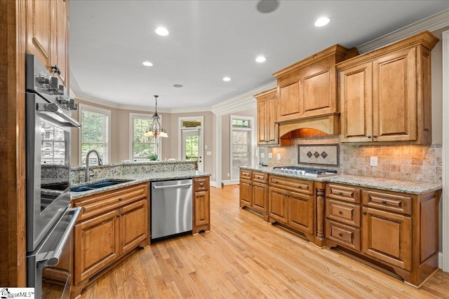 112 Griffith Hill Way, Greer, SC 29650 - kitchen with stainless steel appliances, light wood-style floors, crown molding, backsplash, and light stone counters