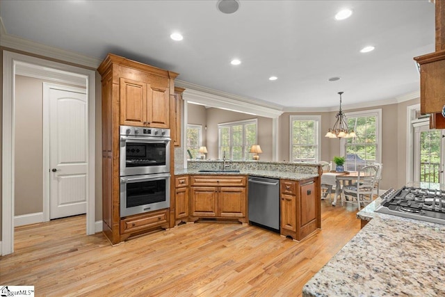 112 Griffith Hill Way, Greer, SC 29650 - kitchen with stainless steel appliances, ornamental molding, light wood finished floors, a peninsula, and brown cabinets
