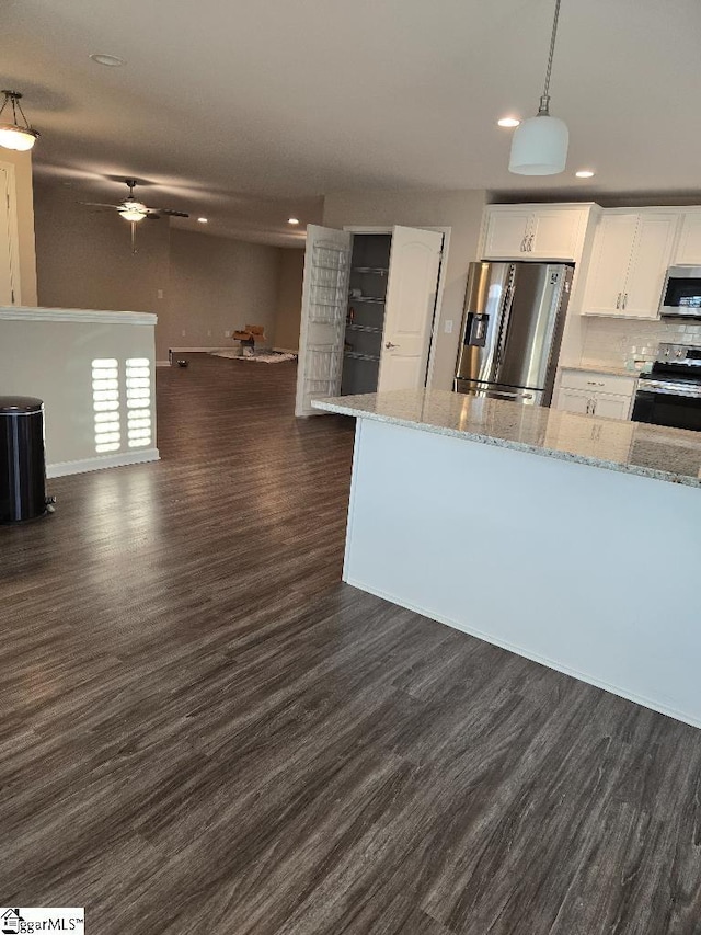 303 Plantation Pt, Anderson, SC 29625 - kitchen featuring stainless steel appliances, recessed lighting, dark wood-type flooring, white cabinets, and light stone counters