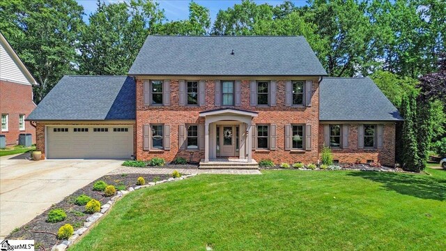 502 Sugar Valley Ct, Greer, SC 29650 - colonial home with an attached garage, driveway, a front lawn, and brick siding