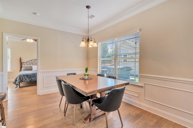 402 Birchbark Ln, Lyman, SC 29365 - dining space with light wood finished floors, crown molding, wainscoting, a chandelier, and plenty of natural light