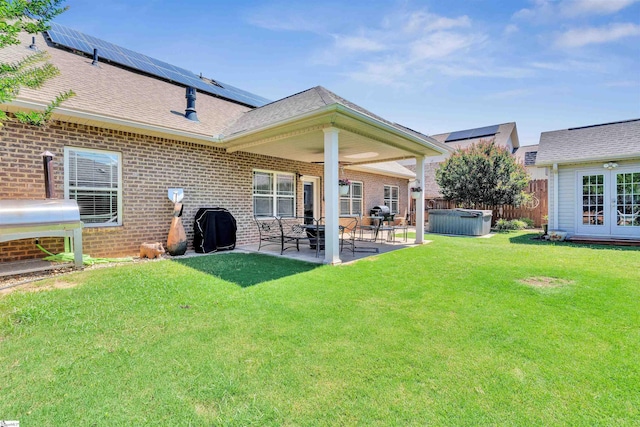 402 Birchbark Ln, Lyman, SC 29365 - back of house featuring a hot tub, a patio, brick siding, roof mounted solar panels, and french doors