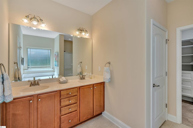 402 Birchbark Ln, Lyman, SC 29365 - full bath with tile patterned flooring, double vanity, a walk in closet, and a tub to relax in