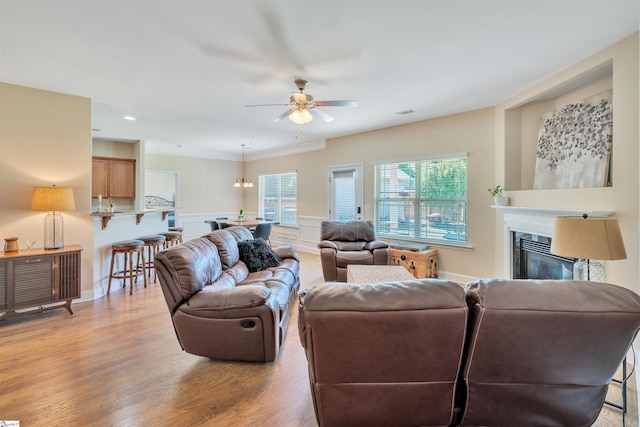 402 Birchbark Ln, Lyman, SC 29365 - living area featuring a ceiling fan, a glass covered fireplace, light wood-type flooring, a wainscoted wall, and recessed lighting