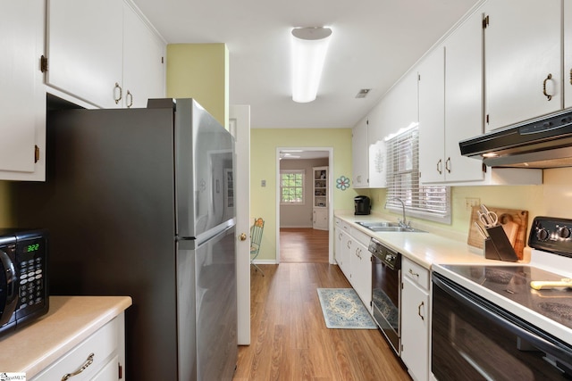 310 Downs Blvd, Clemson, SC 29631 - kitchen featuring black appliances, under cabinet range hood, light wood finished floors, white cabinets, and light countertops