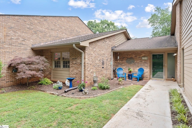 310 Downs Blvd, Clemson, SC 29631 - property entrance with brick siding, a yard, a patio area, and roof with shingles