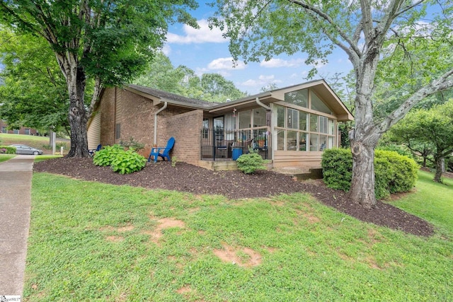 310 Downs Blvd, Clemson, SC 29631 - view of front of home featuring brick siding, a front yard, and a sunroom