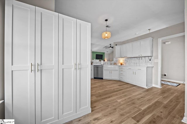 521 Omniwood Ct, Greer, SC 29651 - kitchen featuring white cabinets, decorative backsplash, light wood-type flooring, dishwasher, and light countertops