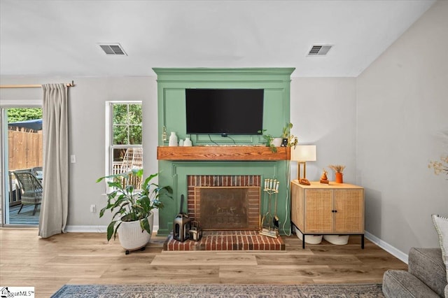 521 Omniwood Ct, Greer, SC 29651 - living room featuring a brick fireplace and wood finished floors
