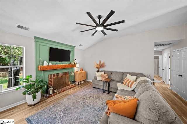 521 Omniwood Ct, Greer, SC 29651 - living area with wood finished floors, ceiling fan, a brick fireplace, and lofted ceiling