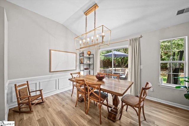 521 Omniwood Ct, Greer, SC 29651 - dining area with light wood finished floors, vaulted ceiling, and a chandelier