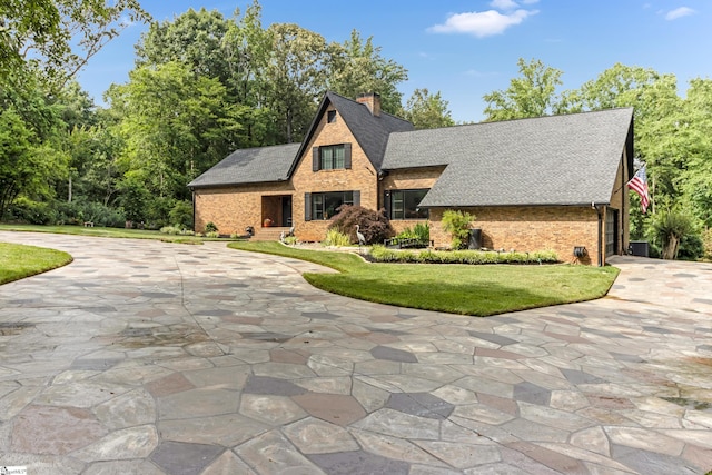 106 Riverbank Ct, Moore, SC 29369 - view of front facade with brick siding, a chimney, and concrete driveway