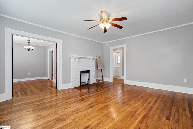 1706 Park Dr, Anderson, SC 29625 - unfurnished living room featuring a ceiling fan, a chandelier, hardwood / wood-style flooring, crown molding, and a fireplace