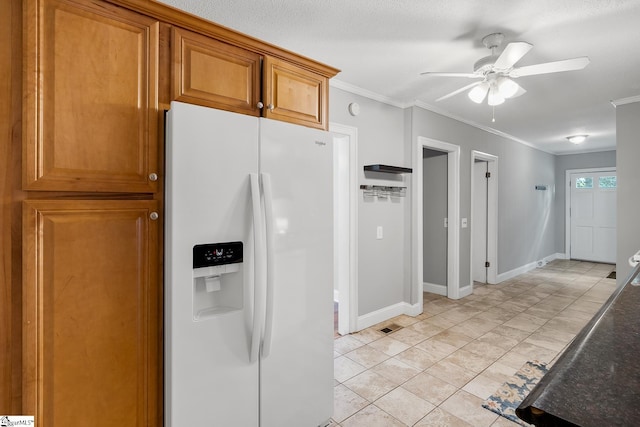 1706 Park Dr, Anderson, SC 29625 - kitchen featuring white refrigerator with ice dispenser, ceiling fan, brown cabinetry, crown molding, and dark countertops