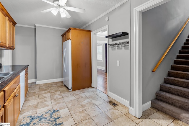 1706 Park Dr, Anderson, SC 29625 - kitchen featuring white appliances, ceiling fan, dark countertops, ornamental molding, and brown cabinets