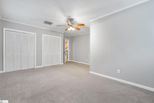 1706 Park Dr, Anderson, SC 29625 - unfurnished bedroom with multiple closets, ornamental molding, carpet, and ceiling fan