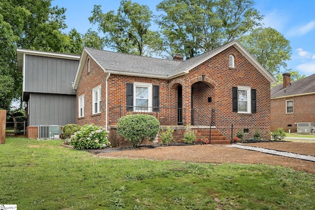 1706 Park Dr, Anderson, SC 29625 - view of front of home featuring brick siding, a front lawn, roof with shingles, and a chimney