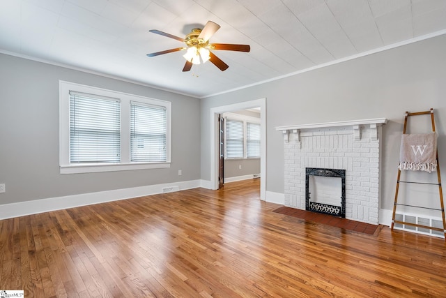 1706 Park Dr, Anderson, SC 29625 - unfurnished living room with a ceiling fan, crown molding, a brick fireplace, and wood-type flooring