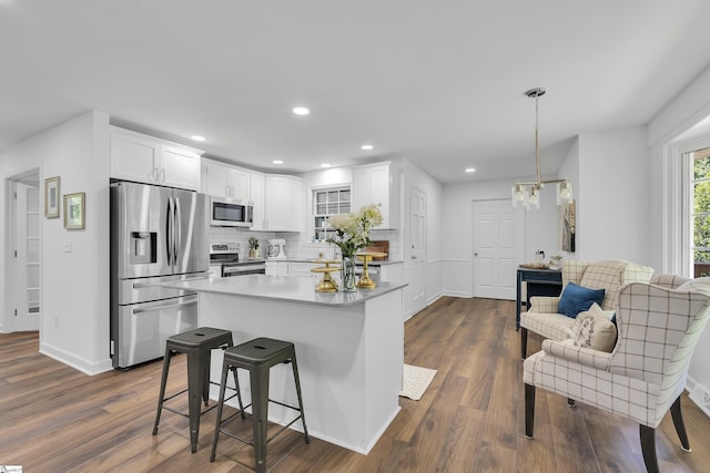 505 E Hackney Rd, Greer, SC 29650 - kitchen featuring stainless steel appliances, white cabinets, dark wood-type flooring, decorative backsplash, and light countertops