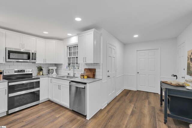 505 E Hackney Rd, Greer, SC 29650 - kitchen with stainless steel appliances, dark wood-style floors, white cabinetry, decorative backsplash, and light countertops