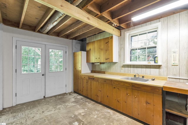 505 E Hackney Rd, Greer, SC 29650 - kitchen with brown cabinets, light countertops, wooden walls, and light stone finish flooring