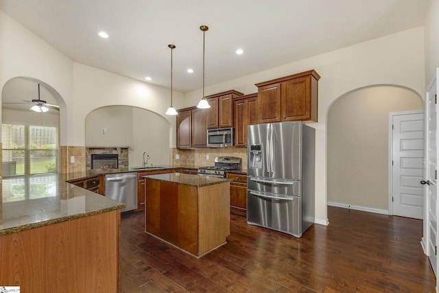27 Dandie Dr, Simpsonville, SC 29680 - kitchen with appliances with stainless steel finishes, arched walkways, dark stone countertops, backsplash, and recessed lighting