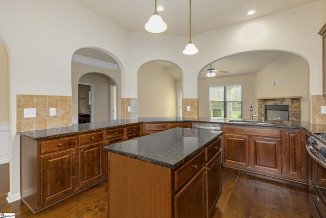 27 Dandie Dr, Simpsonville, SC 29680 - kitchen with a peninsula, ceiling fan, dark wood-style flooring, stainless steel appliances, and tasteful backsplash