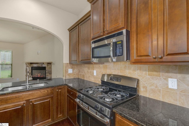 27 Dandie Dr, Simpsonville, SC 29680 - kitchen featuring stainless steel appliances, arched walkways, backsplash, and dark stone countertops
