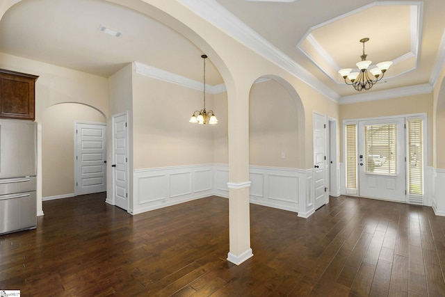 27 Dandie Dr, Simpsonville, SC 29680 - foyer featuring a chandelier, wainscoting, dark wood finished floors, a raised ceiling, and crown molding