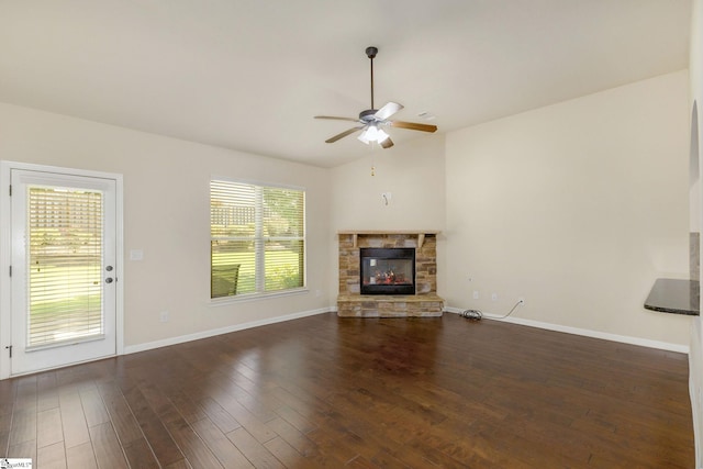27 Dandie Dr, Simpsonville, SC 29680 - unfurnished living room with a ceiling fan, a stone fireplace, dark wood finished floors, and vaulted ceiling