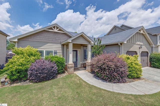 27 Dandie Dr, Simpsonville, SC 29680 - view of front of property with a front yard, an attached garage, board and batten siding, and concrete driveway