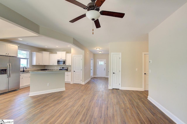 918 Belton Hwy, Williamston, SC 29691 - kitchen featuring appliances with stainless steel finishes, wood finished floors, a center island, white cabinetry, and a ceiling fan