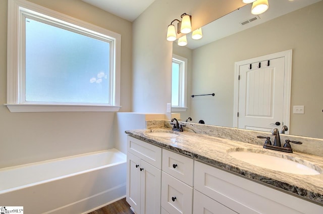 918 Belton Hwy, Williamston, SC 29691 - bathroom with double vanity, a garden tub, and wood finished floors