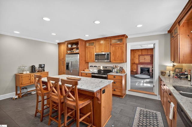 260 Riggs Dr, Clemson, SC 29631 - kitchen featuring stainless steel appliances, crown molding, decorative backsplash, brown cabinets, and recessed lighting