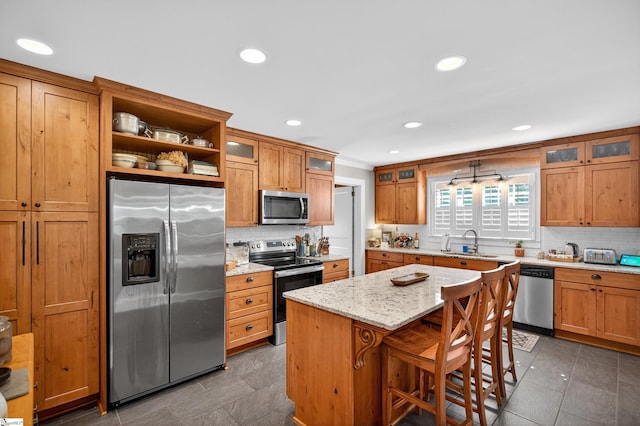 260 Riggs Dr, Clemson, SC 29631 - kitchen with stainless steel appliances, backsplash, brown cabinetry, and recessed lighting