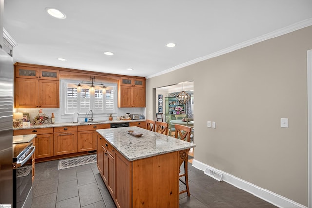 260 Riggs Dr, Clemson, SC 29631 - kitchen featuring range, decorative backsplash, a kitchen breakfast bar, a kitchen island, and crown molding