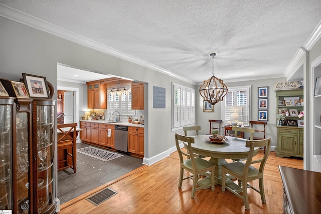 260 Riggs Dr, Clemson, SC 29631 - dining area featuring a chandelier, ornamental molding, a textured ceiling, and light wood-style flooring