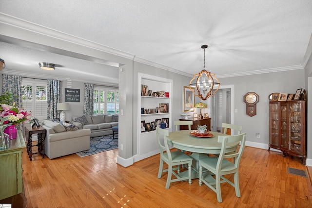 260 Riggs Dr, Clemson, SC 29631 - dining space with a chandelier, light wood-style floors, crown molding, and a textured ceiling