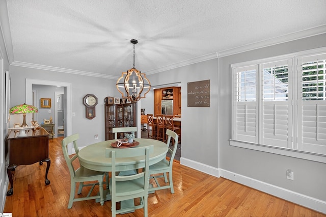 260 Riggs Dr, Clemson, SC 29631 - dining space with a textured ceiling, a chandelier, light wood-style flooring, and ornamental molding