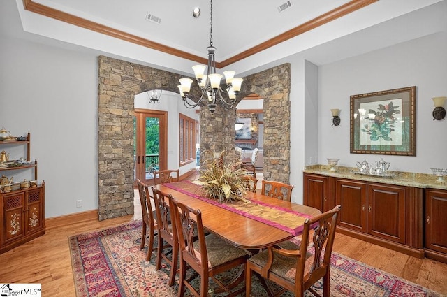 915 Rippling Water Way, Salem, SC 29676 - dining space featuring a chandelier, light wood-style floors, a tray ceiling, and ornamental molding