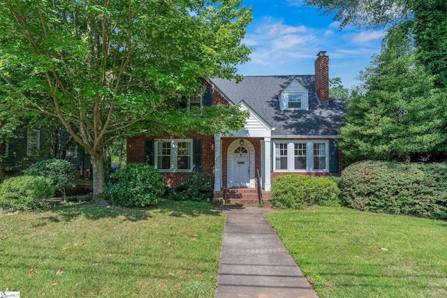 306 Mcdaniel Ave, Greenville, SC 29601 - view of front of house with a chimney, brick siding, and a front lawn