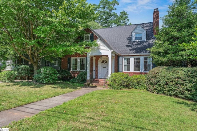 306 Mcdaniel Ave, Greenville, SC 29601 - view of front of property featuring brick siding, a chimney, and a front lawn