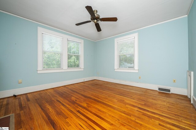 306 Mcdaniel Ave, Greenville, SC 29601 - unfurnished room with ornamental molding, plenty of natural light, wood finished floors, and a ceiling fan