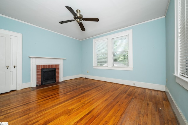 306 Mcdaniel Ave, Greenville, SC 29601 - unfurnished living room featuring plenty of natural light, a fireplace, hardwood / wood-style floors, a ceiling fan, and crown molding