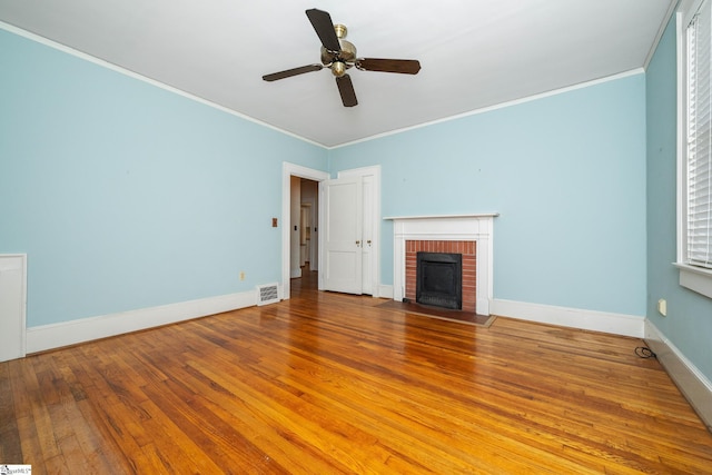 306 Mcdaniel Ave, Greenville, SC 29601 - unfurnished living room featuring a fireplace, hardwood / wood-style flooring, ornamental molding, and a ceiling fan