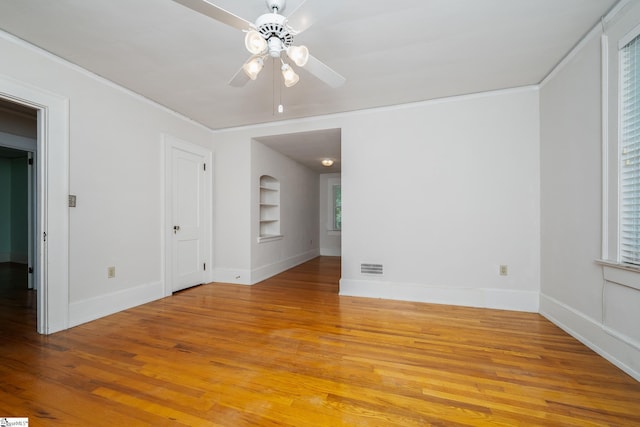 306 Mcdaniel Ave, Greenville, SC 29601 - unfurnished room with built in shelves, light wood-style floors, crown molding, and a ceiling fan
