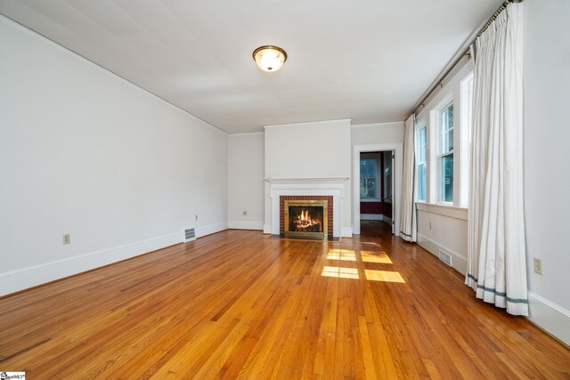 306 Mcdaniel Ave, Greenville, SC 29601 - unfurnished living room featuring light wood-style flooring and a fireplace