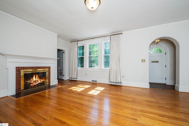 306 Mcdaniel Ave, Greenville, SC 29601 - unfurnished living room featuring arched walkways, plenty of natural light, and wood finished floors