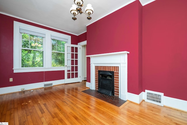 306 Mcdaniel Ave, Greenville, SC 29601 - unfurnished living room featuring crown molding, wood-type flooring, a fireplace, and a chandelier